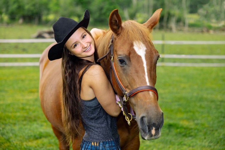 Hayley hugging her horse